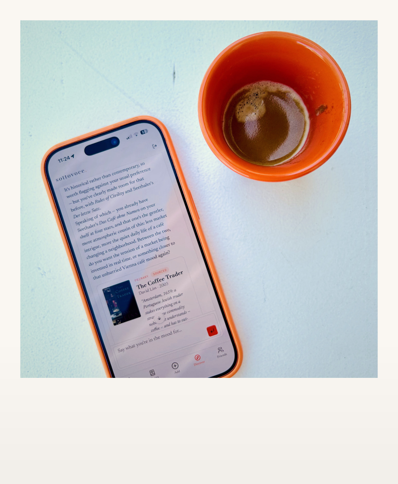 sottovoce app on a phone next to an espresso cup